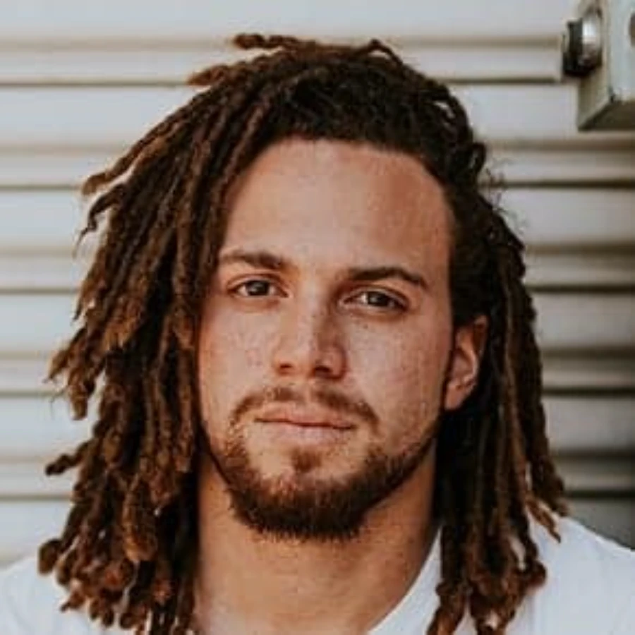 Luis Sweat - confident young professional man with dreadlocks headshot portrait