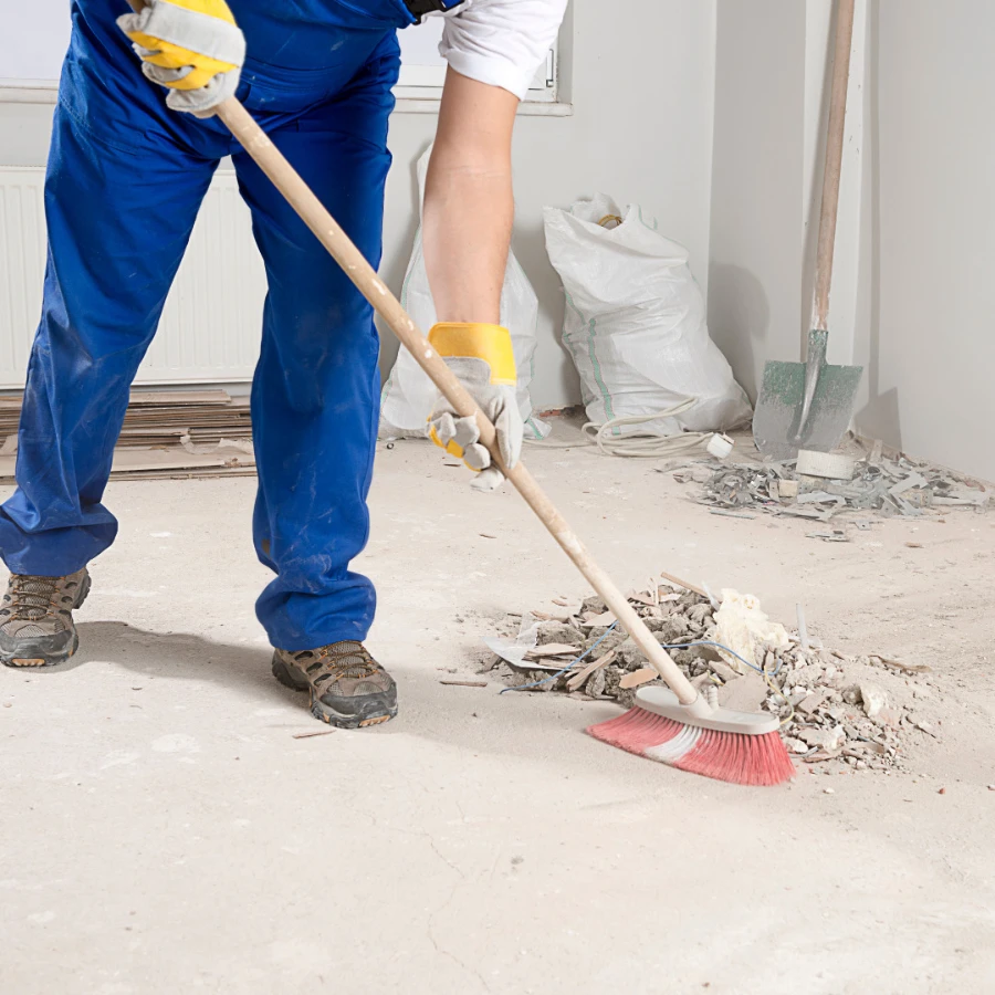 Post-Construction Cleaning Fort Myers worker sweeping debris and dust after renovation in home interior