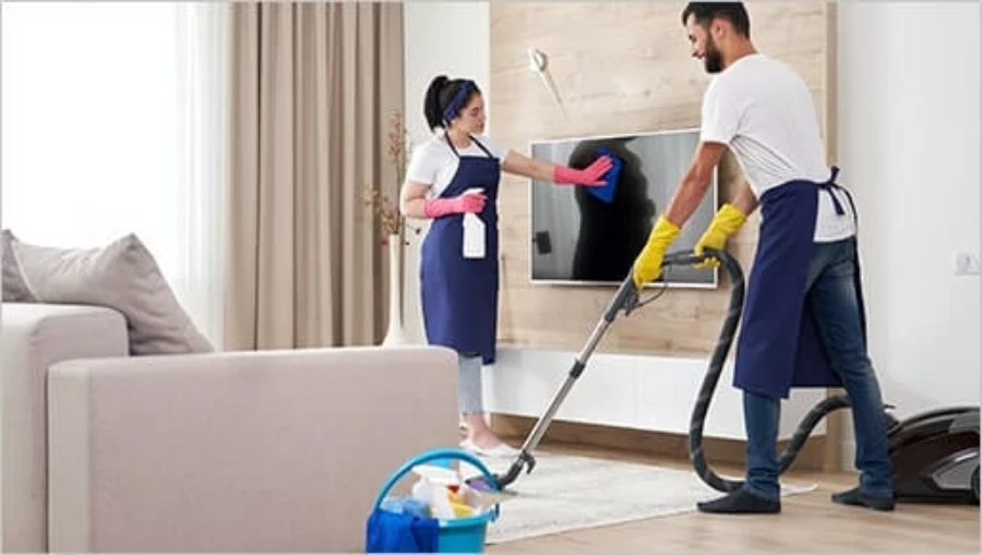 House cleaning in Gulf Harbour Fort Myers FL team vacuuming and wiping surfaces in living room